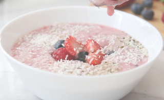 A bowl of raspberry flavoured oatmeal from Ener-C's raspberry Vitamin C mixed with fresh fruit on top